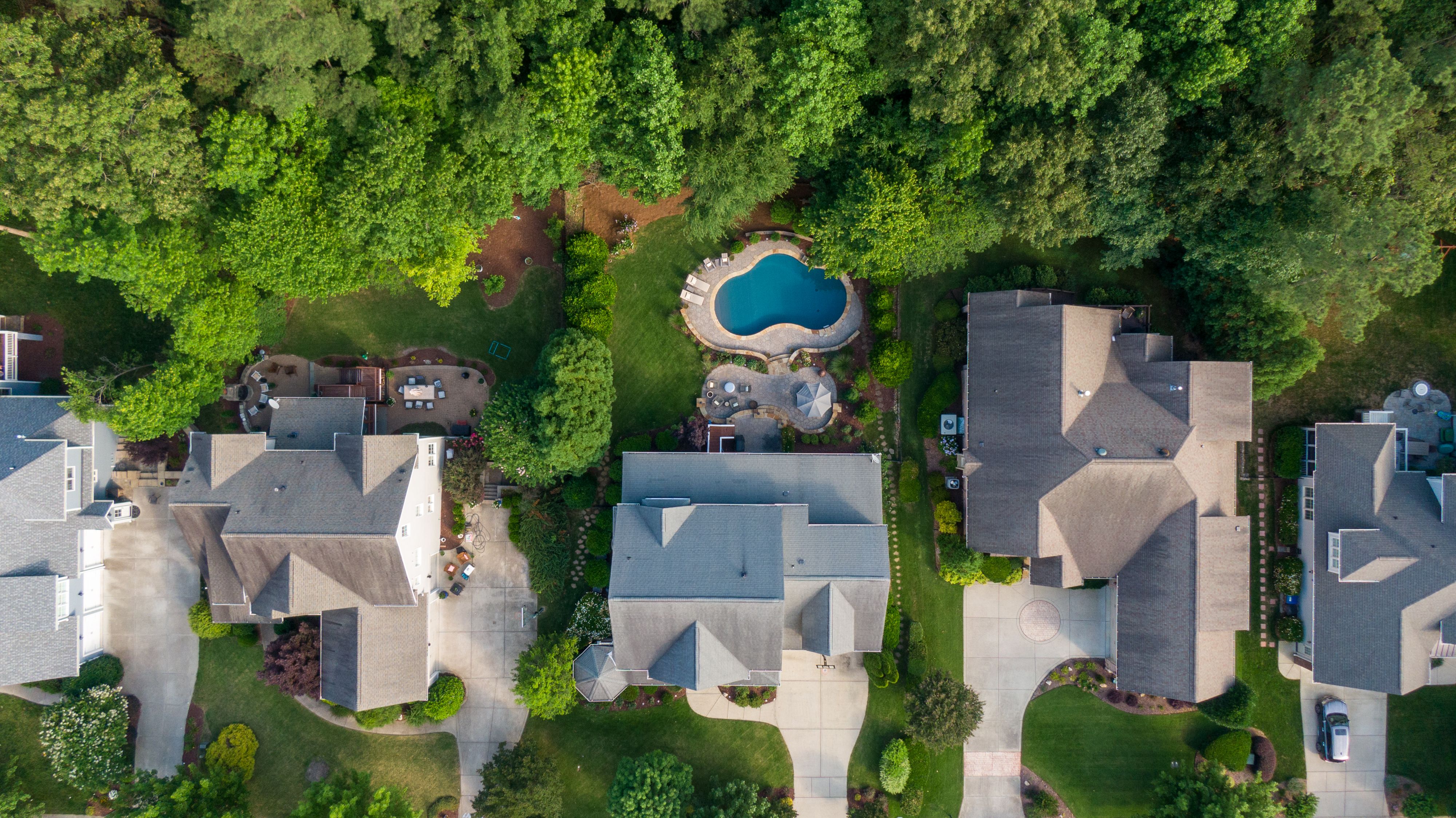 Aerial view showing a rental home's pool and rear yard